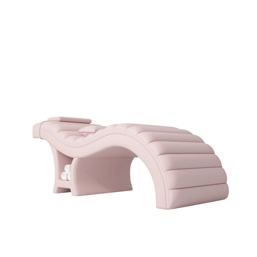 Pink curved salon bed on a white background