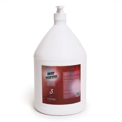 Front view of white gallon bottle labeled Hot Tottie in bold text on a red label with a white pump.