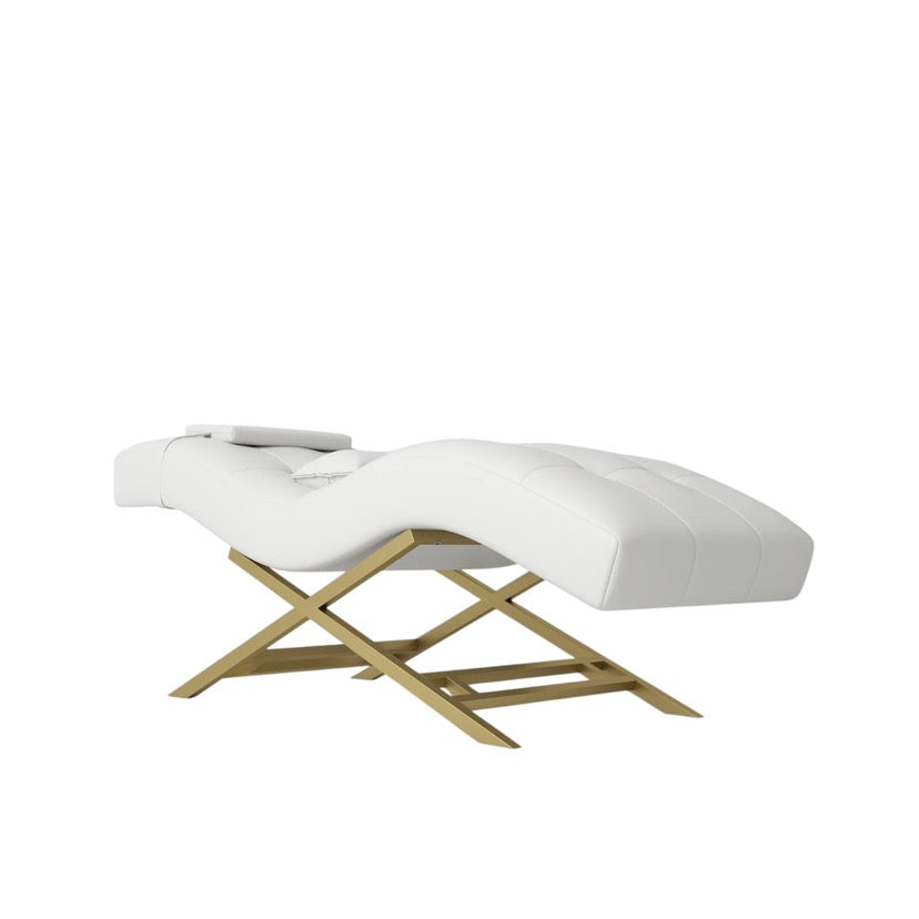 White massage bed with gold frame on a white background